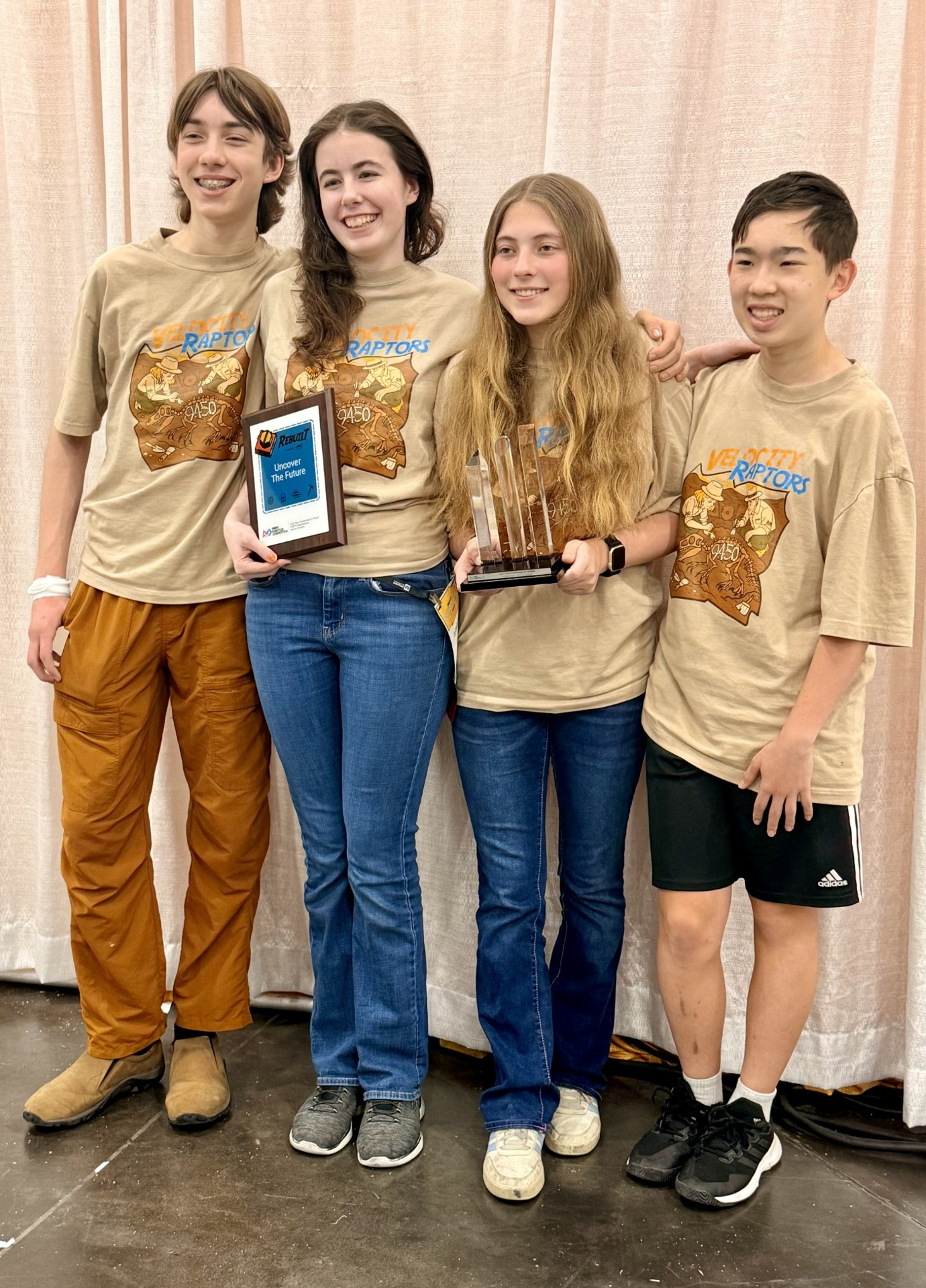 Velocity Raptors Impact team holding the Sustainability Award trophy
